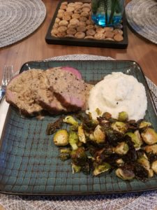 Image of smoked round steak with peppercorn sauce and sides